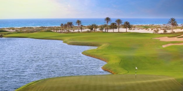 Saadiyat Beach Golf Club with sea in the distance and lake to the left of the fairway
