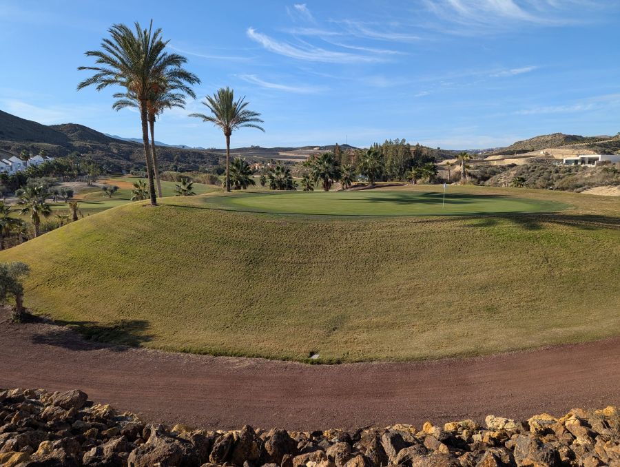 Raised green on the golf course surrounded by the buggy path at Valle Del Este Golf Resort