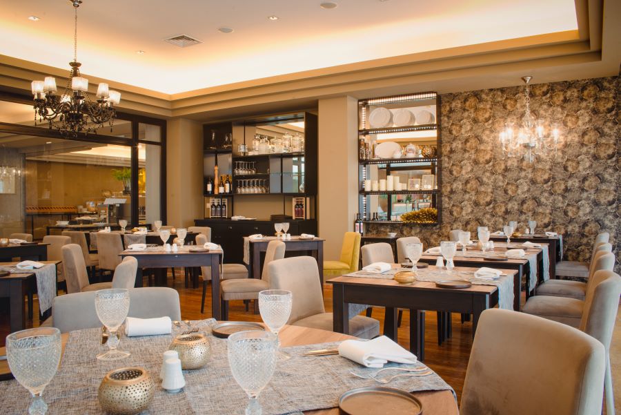 Restaurant with tables set for evening service at Quinta Da Marinha Resort in Cascais, Lisbon