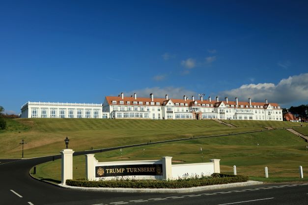 Exterior of Trump Turnberry Golf Resort with the name sign, and the drive leading up to the entrance