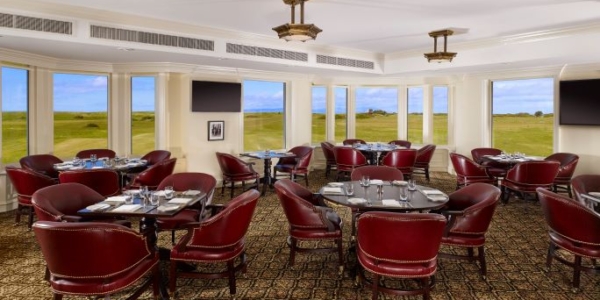 Bar area with television mounted on wall and views over the grounds at Trump Turnberry