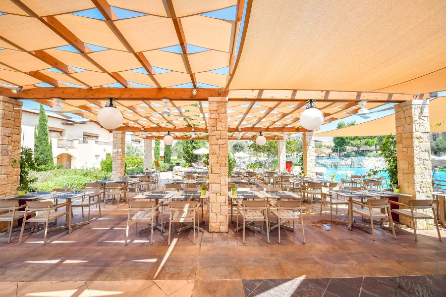 Outdoor dining area at Aphrodite Hills resort in Paphos