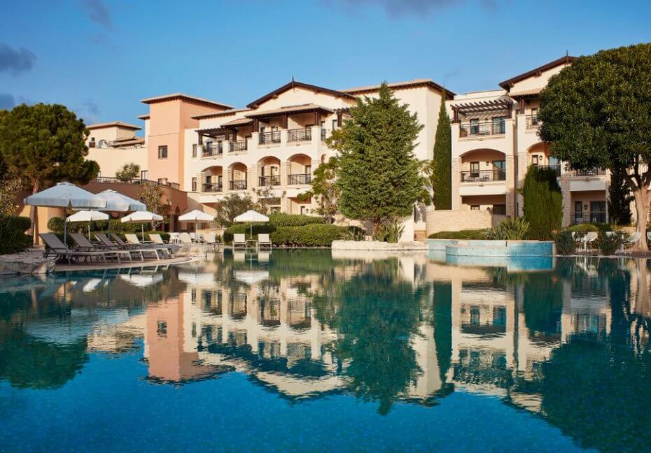 Aphrodite Hills Resort overlooking the swimming pool, sun loungers and trees