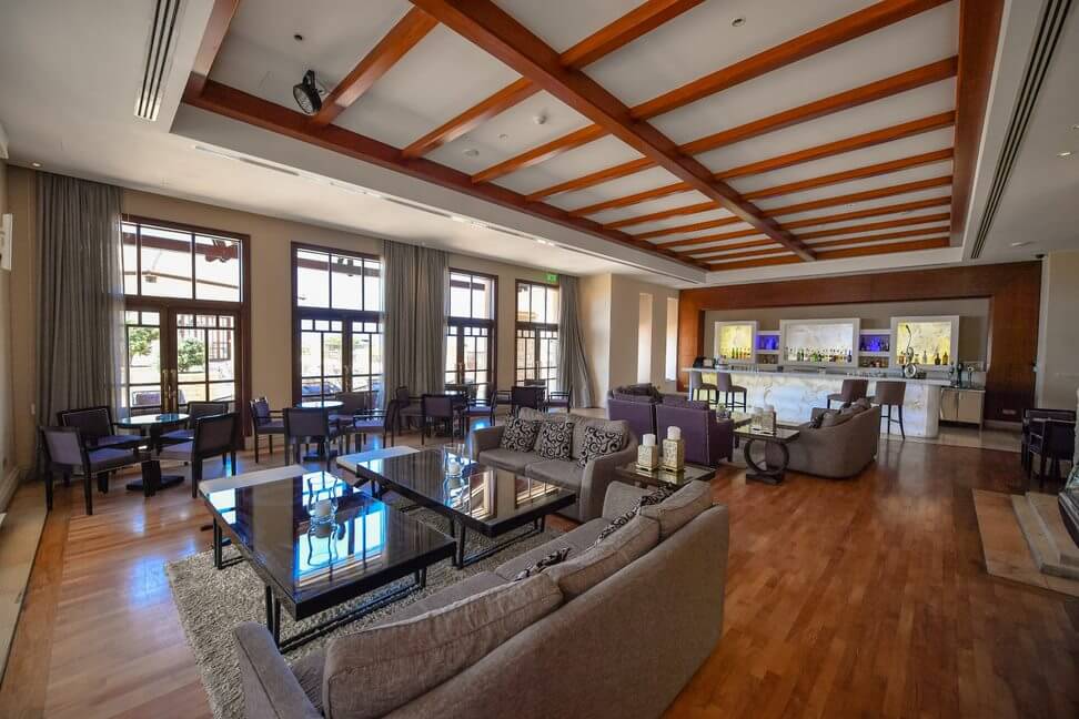 Bar at Aphrodite Hills Resort with grey sofas and purple chairs