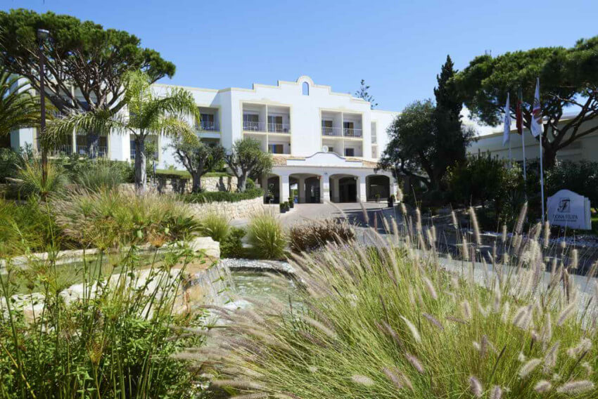 Entrance leading to Dona Filipa Hotel with fountain and gardens