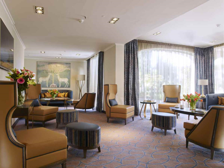 Lobby area with elegant décor, armchairs and footstools in Dona Filipa Hotel