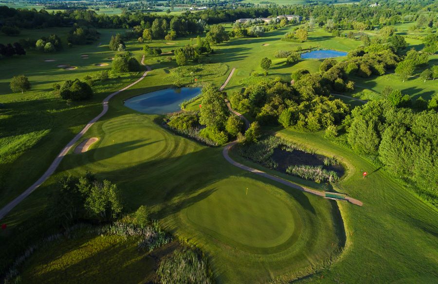 Shot of multiple fairways and lakes from the air at Belton Woods Hotel, Spa And Golf Resort