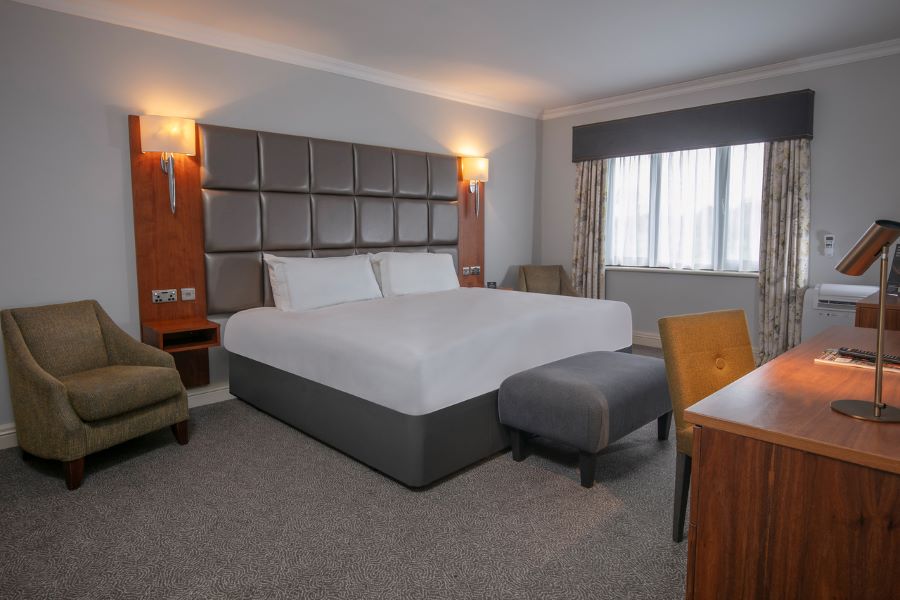 Double bed in the bedroom at Belton Woods Hotel, Spa And Golf Resort