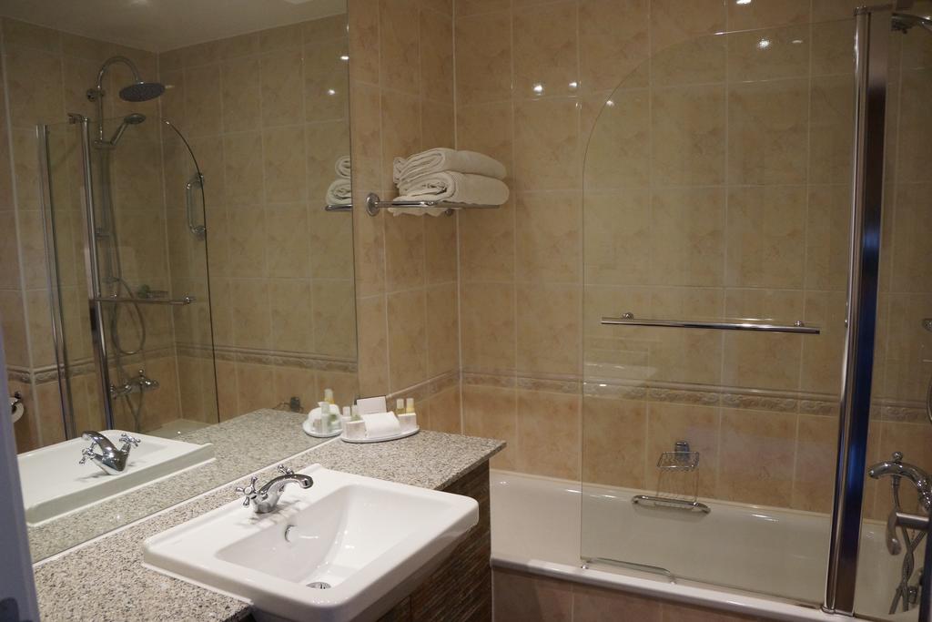Bathroom with sink, bath tub and shower at Carnoustie Golf Hotel And Spa