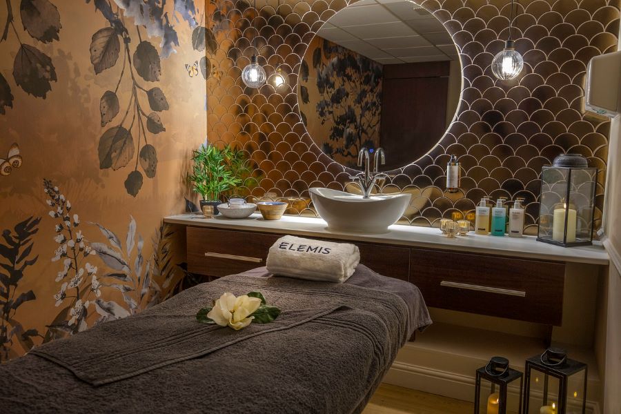 Spa treatment table with towels on it at Dunston Hall Golf And Spa