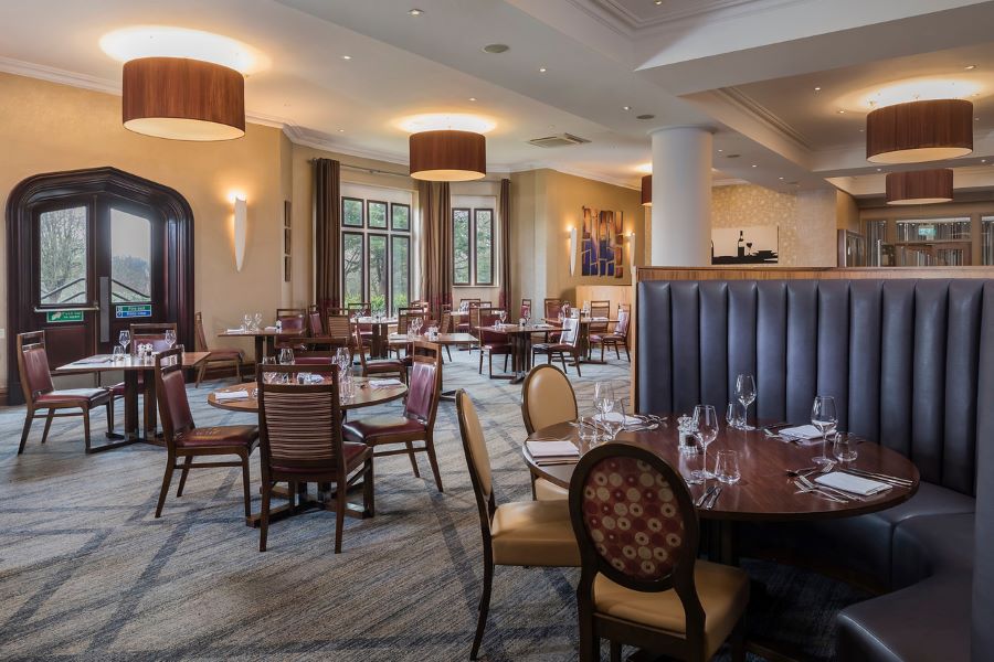Chairs and booths in restaurant at Dunston Hall Golf And Spa