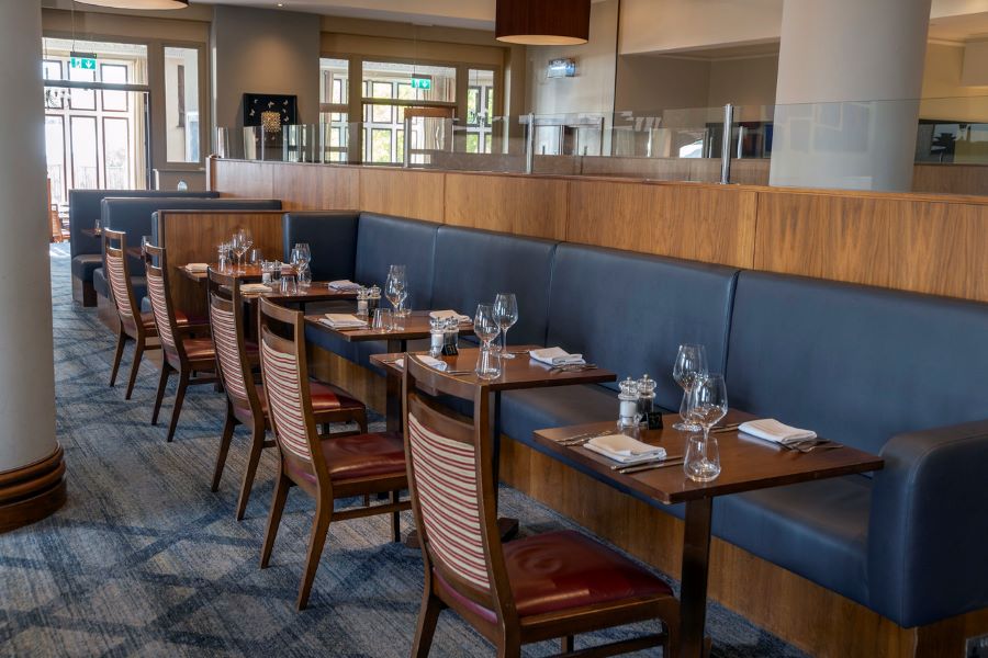 Table and chairs set for service in the restaurant at Dunston Hall Golf And Spa