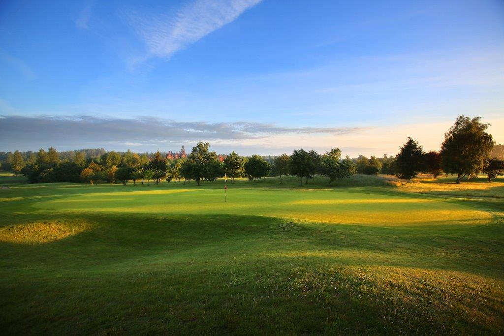 Blue sky over lush green grass on the fairway at Dunston Hall Golf And Spa