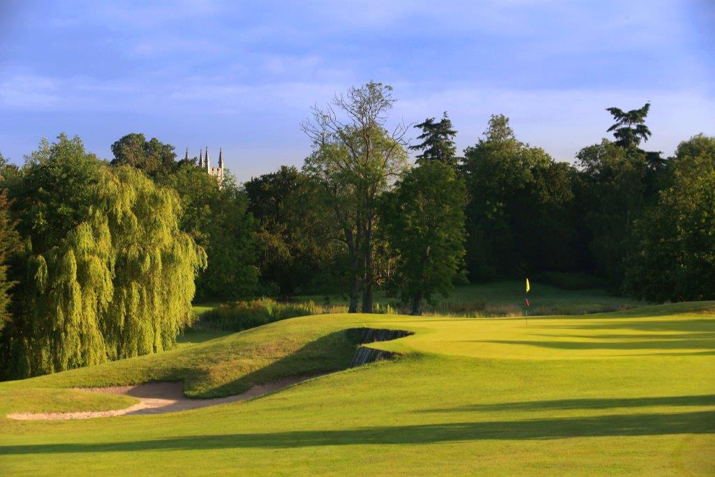 Trees behind the putting green on the course at Dunston Hall Golf And Spa