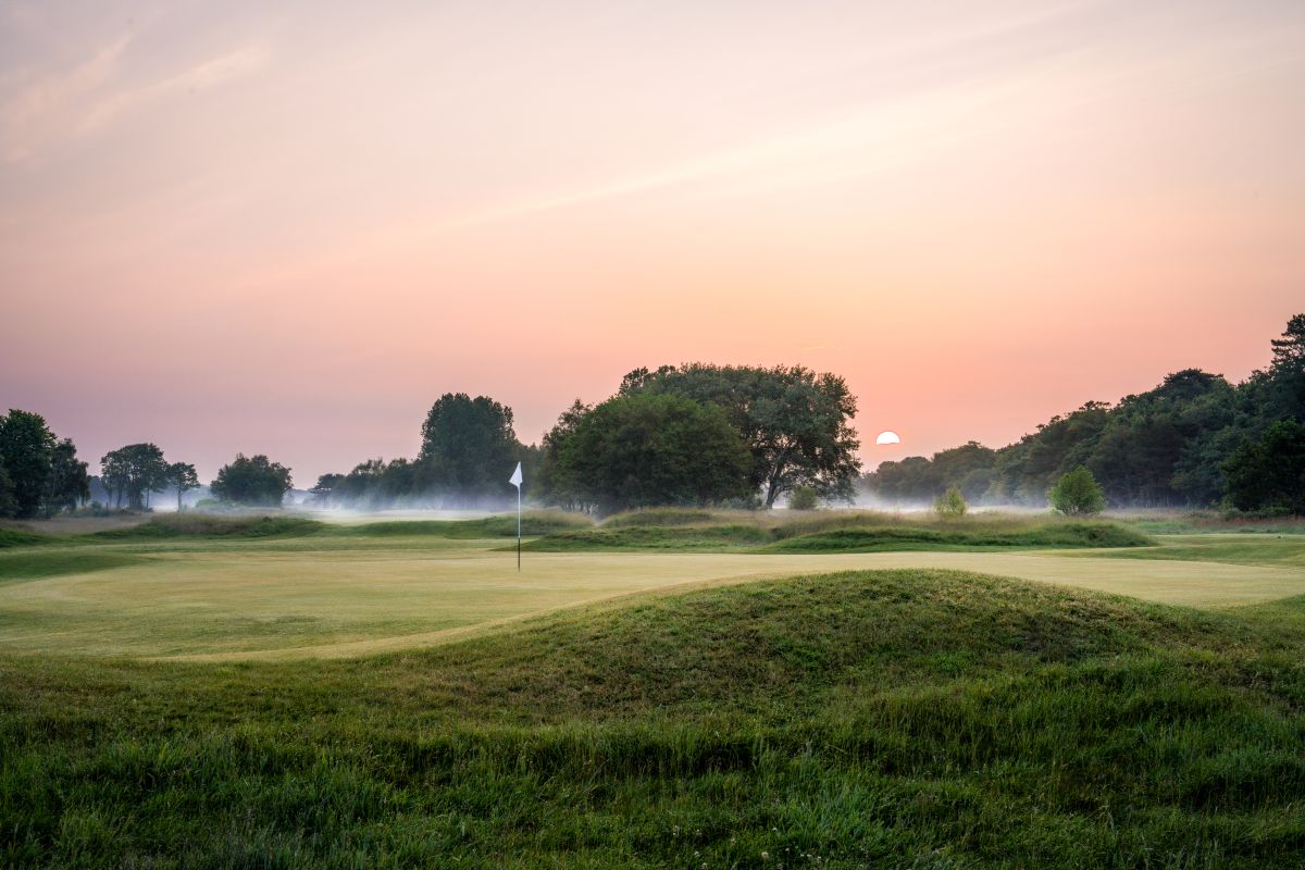 Fairhaven Golf Club at sunrise with flag on the green