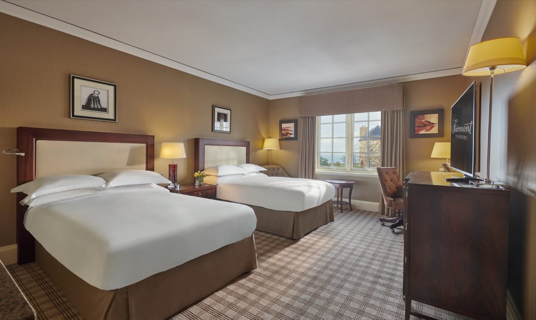 Room with twin beds, desk and chair at Fairmont St Andrews in Scotland