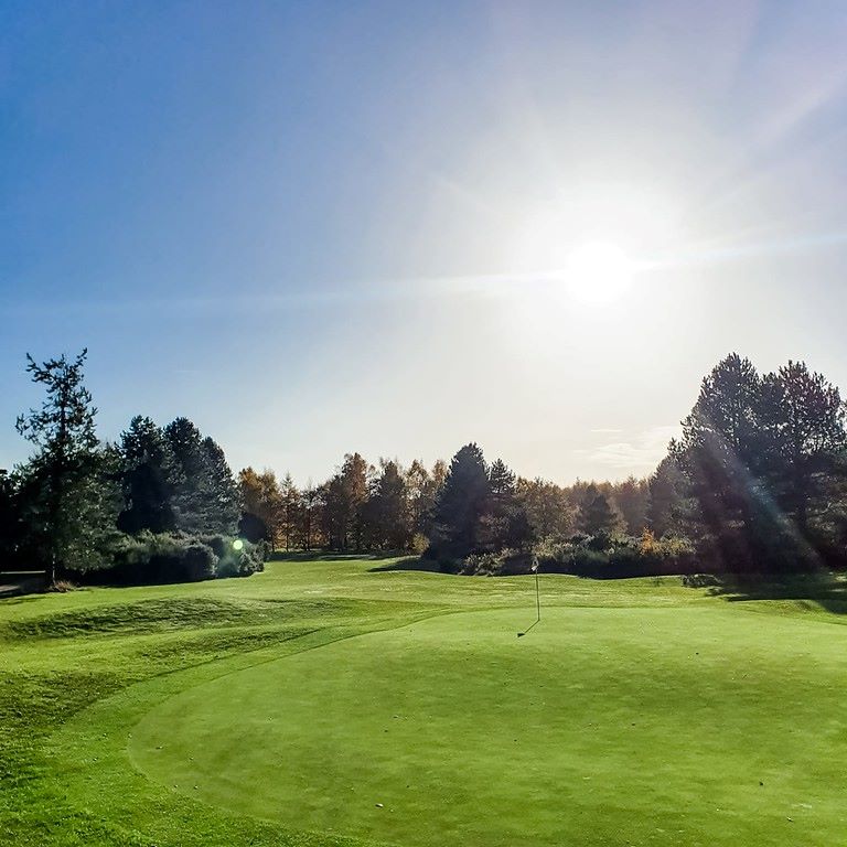 Sun shining above the golf course at Forest Pines Hotel, Spa And Golf Resort