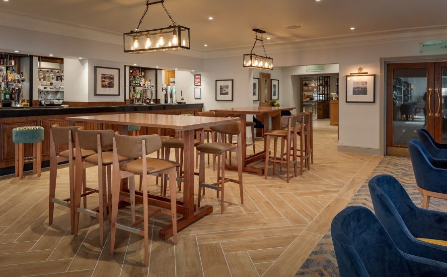 Bar area with high tables and stools at Forest Pines Hotel, Spa And Golf Resort