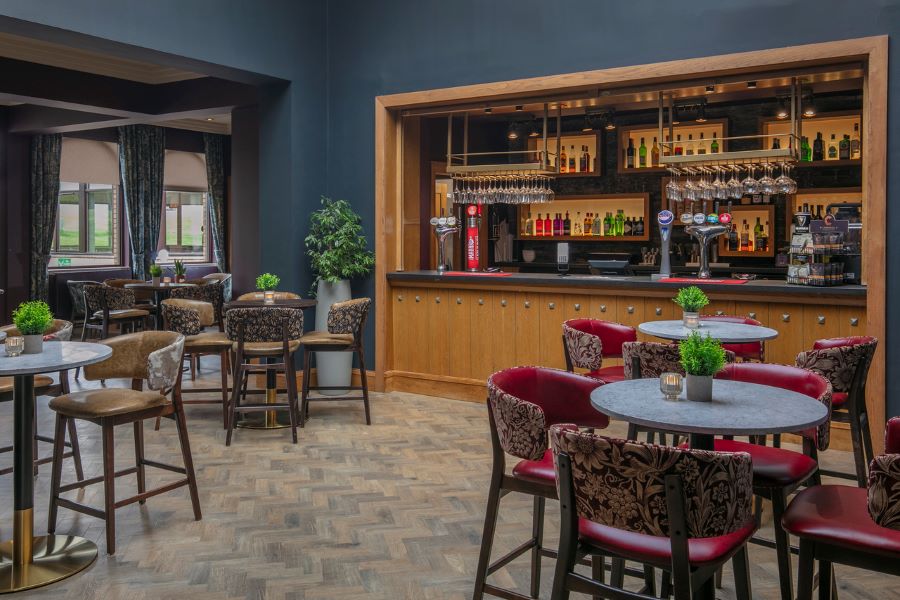 Bar with tables and chairs ready for service at Glasgow Westerwood Hotel, Spa & Golf Resort