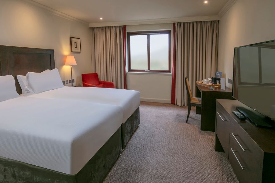 Red chair in twin bed at Glasgow Westerwood Hotel, Spa & Golf Resort