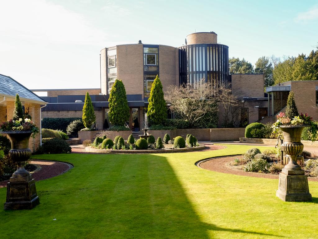 Landscaped gardens at MacDonald Portal Hotel Golf And Spa featuring a water fountain