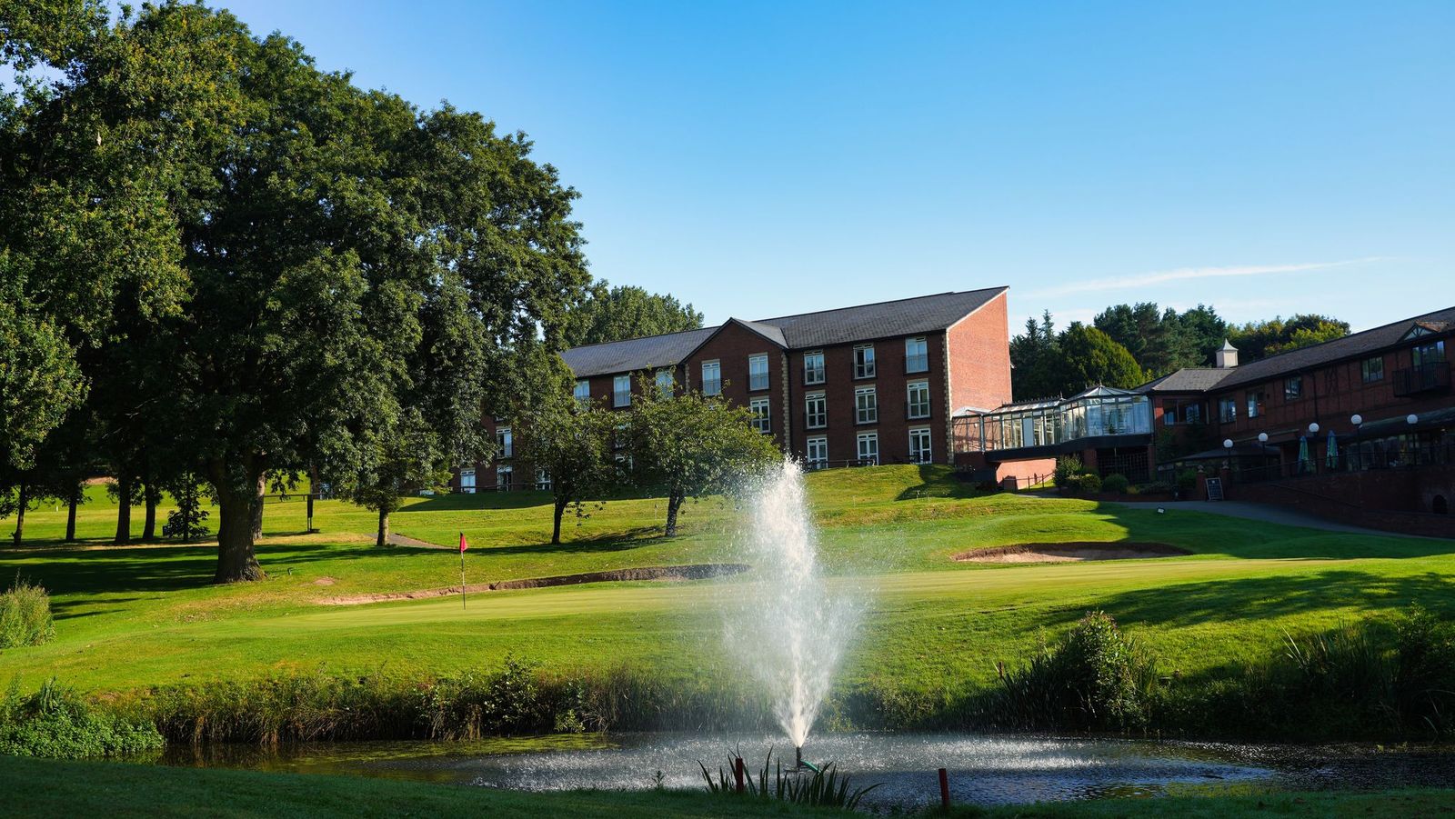 Macdonald Hill Valley Hotel Golf & Spa with fountain in the lake