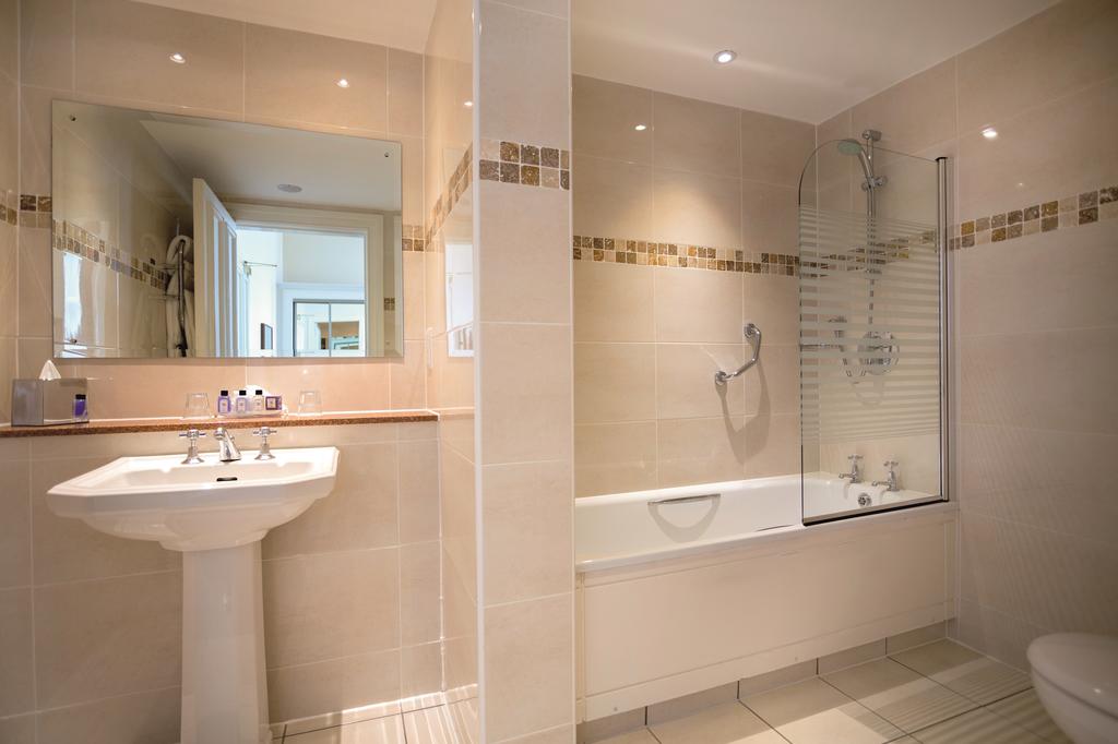 Bathroom with sink, bath tub and shower at Macdonald Linden Hall Golf And Country Club