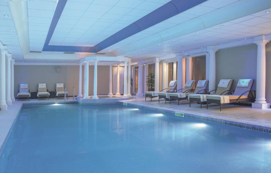 Indoor swimming poll with Jacuzzi and loungers at Macdonald Linden Hall Golf And Country Club