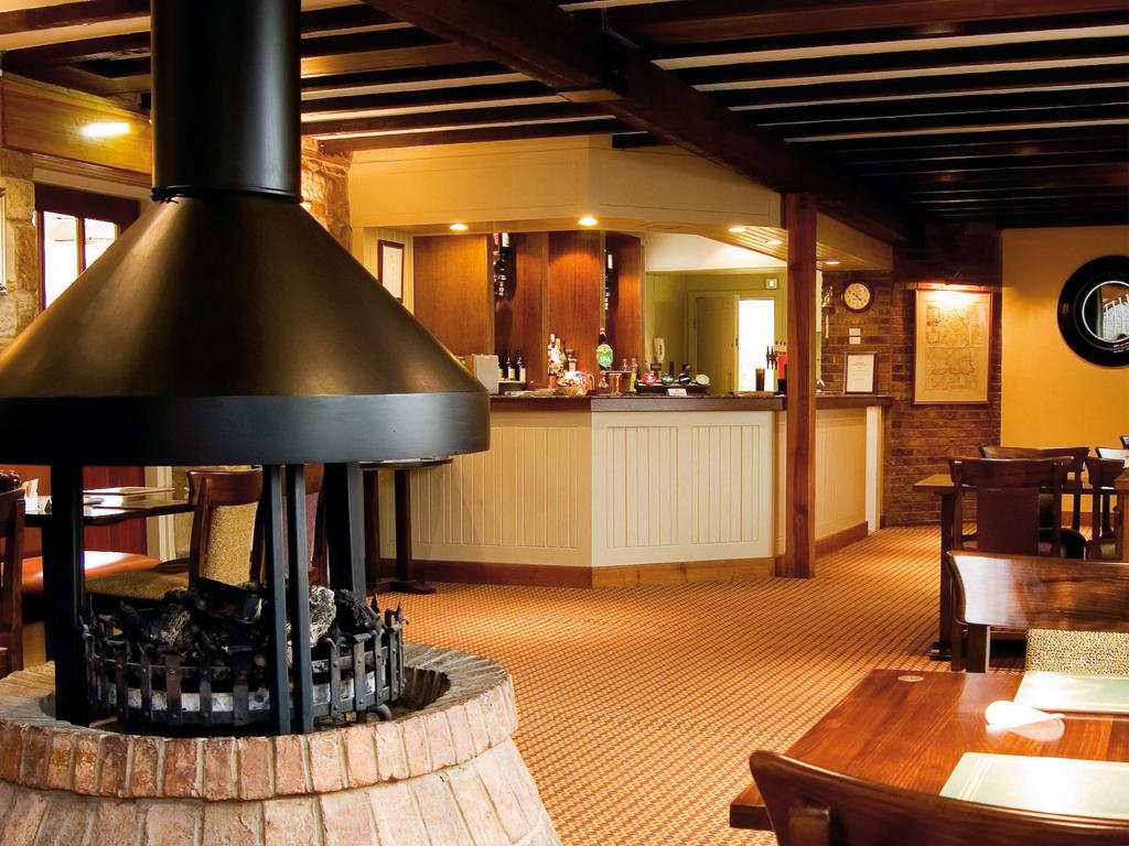 Bar at Macdonald Linden Hall Golf And Country Club with open fire