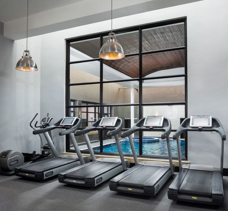 Running machines with view of swimming pool at Oulton Hall Golf Hotel And Spa