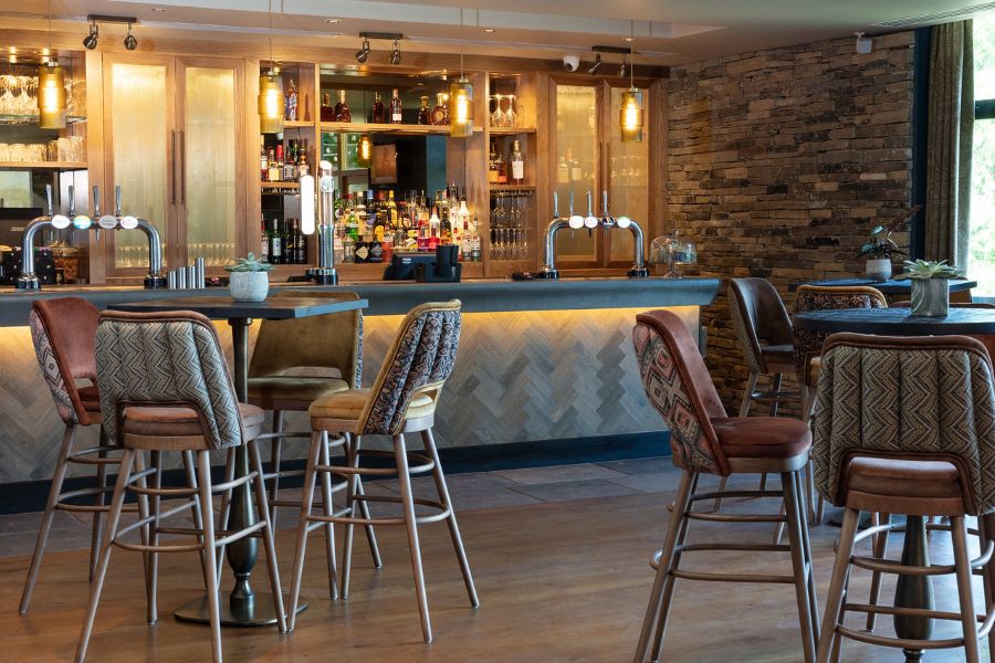 Stools and high tables in bar at Oulton Hall Golf Hotel And Spa