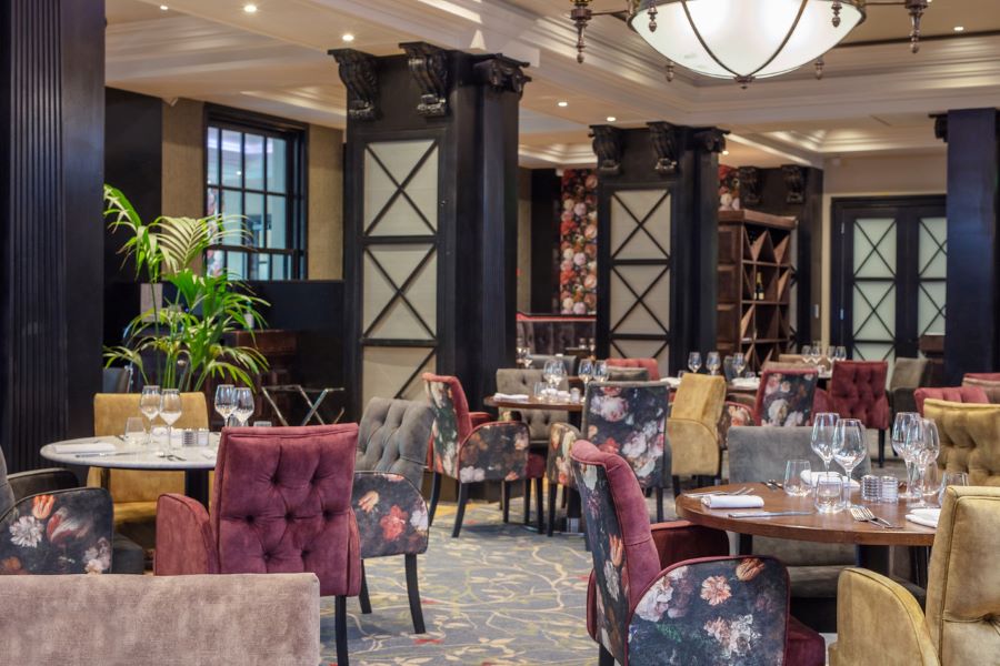 Purple chairs and blue pillars at Oulton Hall Golf Hotel And Spa