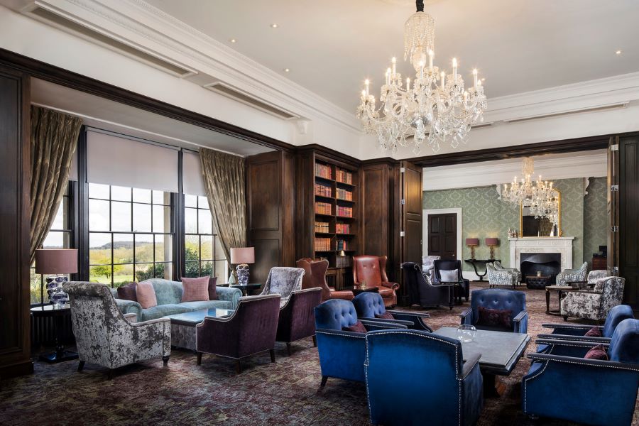 Blue, purple and grey chairs in grand lounge and chandeliers at Oulton Hall Golf Hotel And Spa