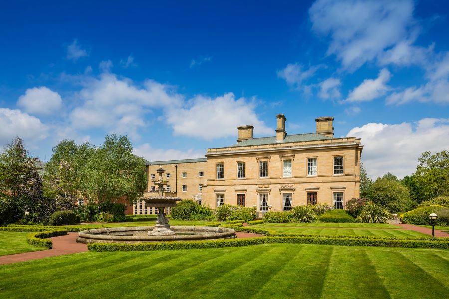 Exterior of Oulton Hall Golf Hotel And Spa with blue sky overhead