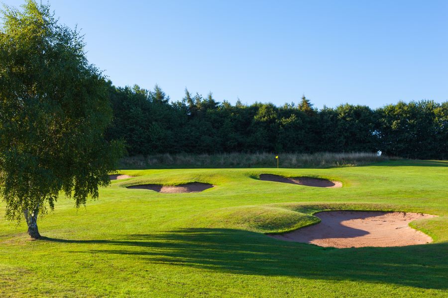 Trees behind the fairway along with 3 sand bunkers at Oulton Hall Golf Hotel And Spa