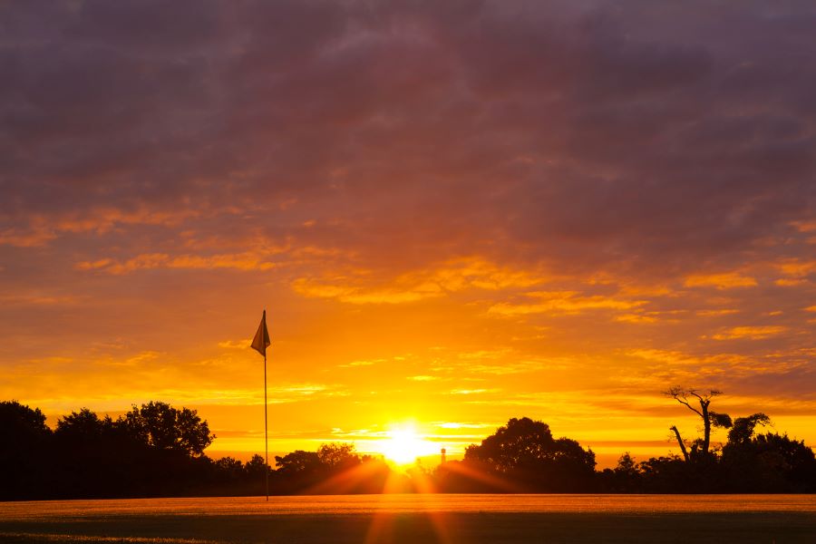 Golf course at sunset with flag on the green at Oulton Hall Golf Hotel And Spa