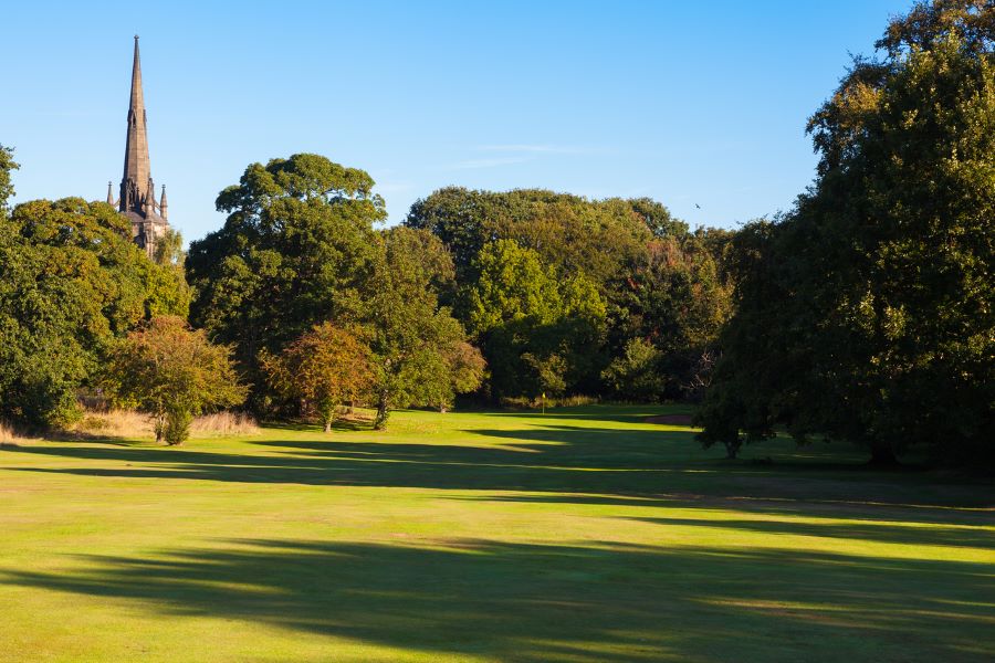 Green trees behind the golf course at Oulton Hall Golf Hotel And Spa