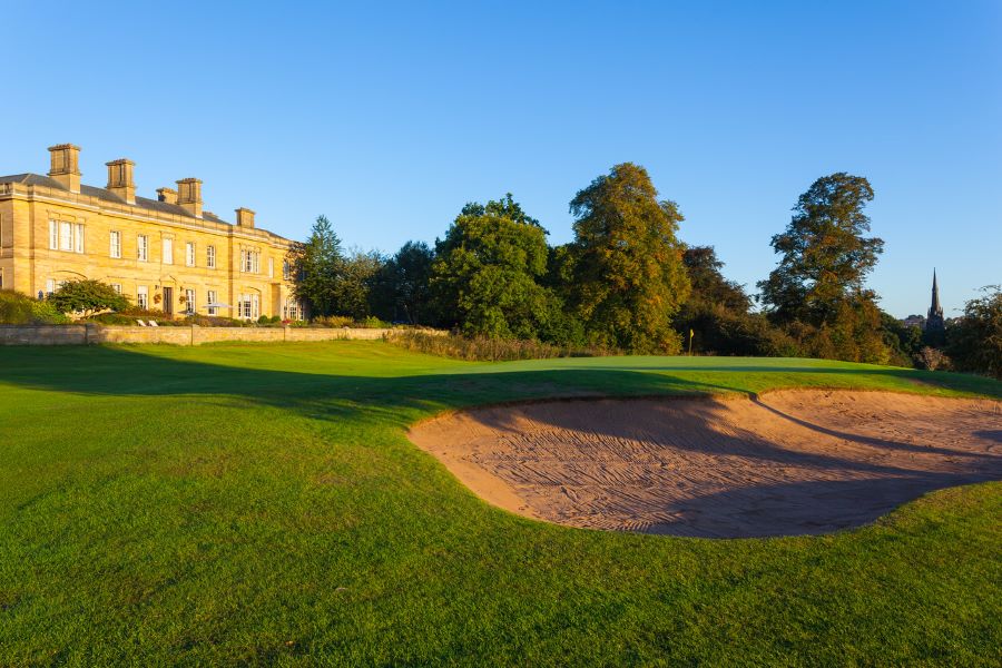 Resort next to golf course, with large sand bunker to the right at Oulton Hall Golf Hotel And Spa