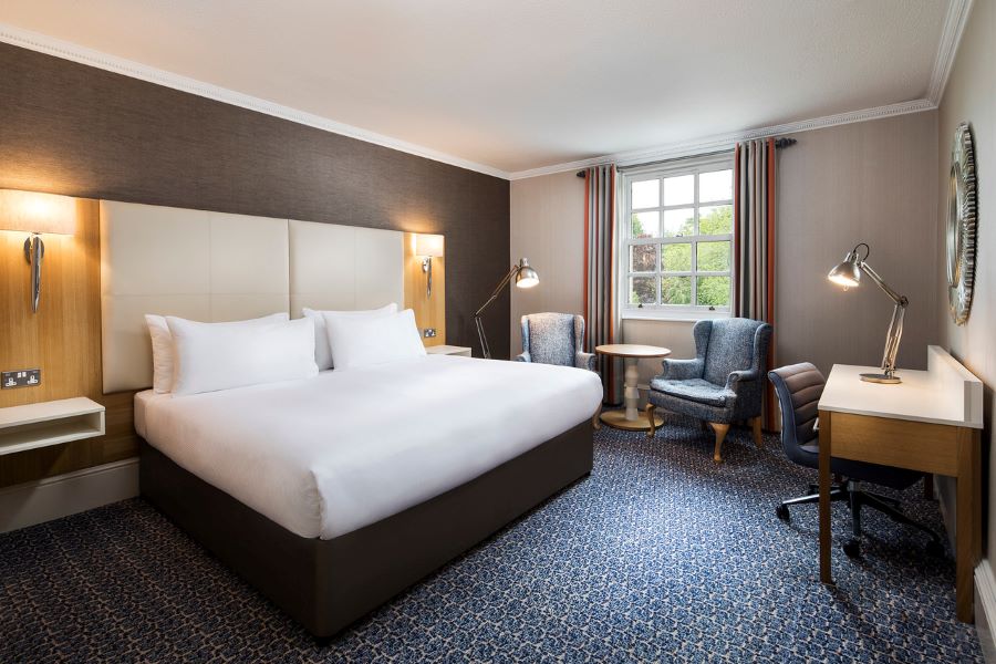 Doubled bed in bedroom at Oulton Hall Golf Hotel And Spa