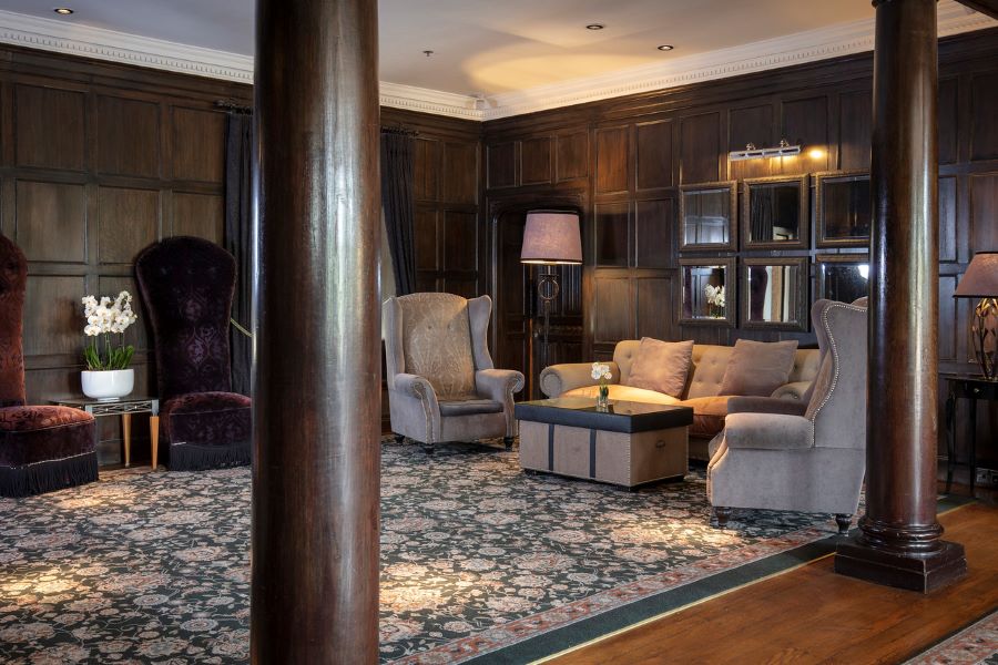 Wing back chair and sofas to relax in at Slaley Hall Hotel, Spa And Golf Resort