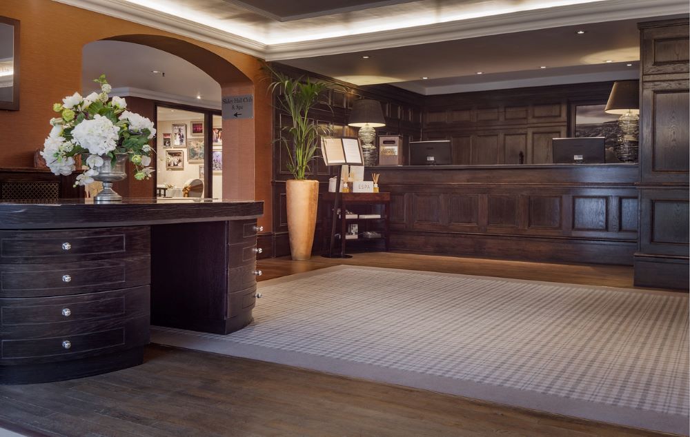Reception and lobby with purple décor at Slaley Hall Hotel, Spa And Golf Resort