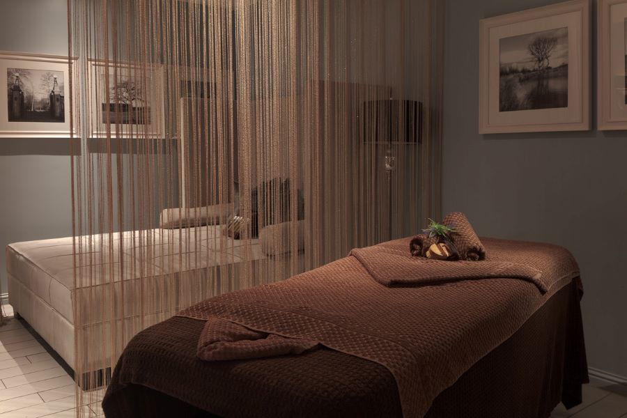 Towels on Spa treatment table with dividing curtain at Slaley Hall Hotel, Spa And Golf Resort