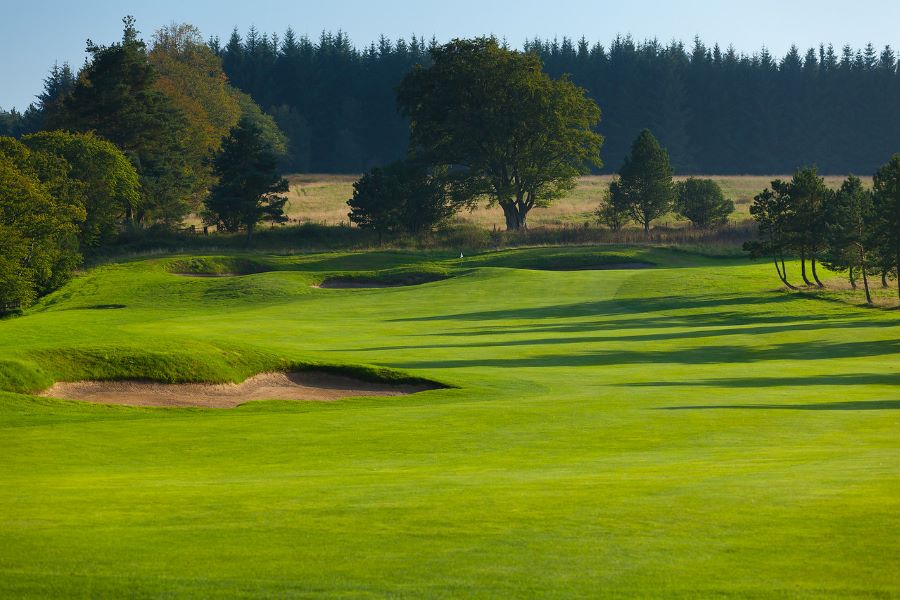 Bunker to the left of the fairway at Slaley Hall Hotel, Spa And Golf Resort and green trees in the distance