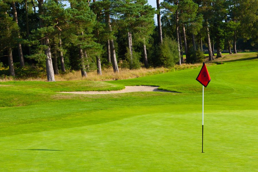 Red flag on the putting green with bunker in the distance at Slaley Hall Hotel, Spa And Golf Resort