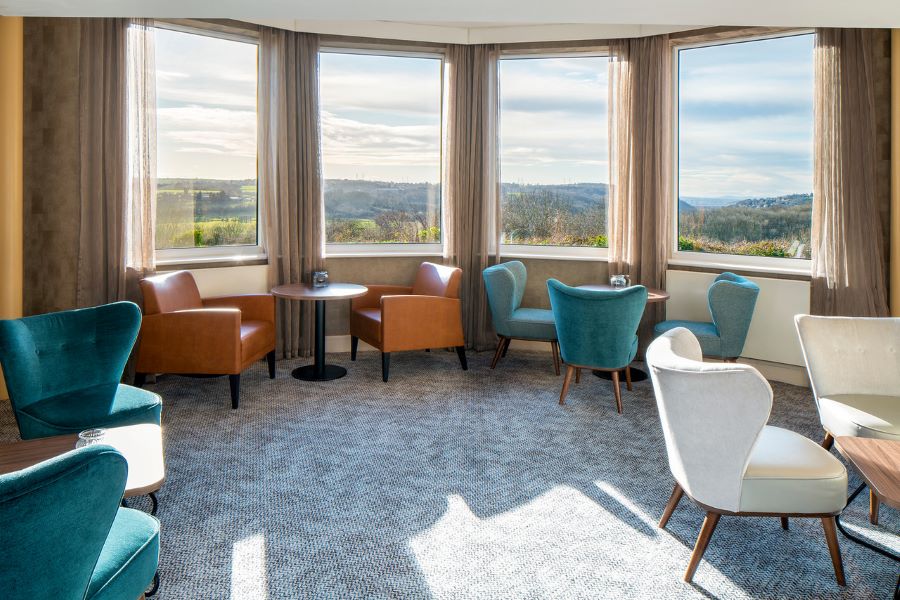 Blue and orange chairs in bar area over looking golf course at The Telford Hotel, Spa And Golf Resort