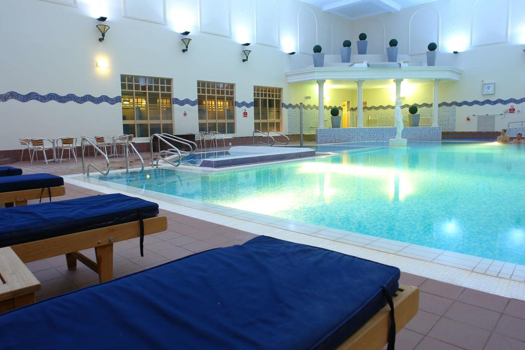 Indoor swimming pool and loungers at Belton Woods