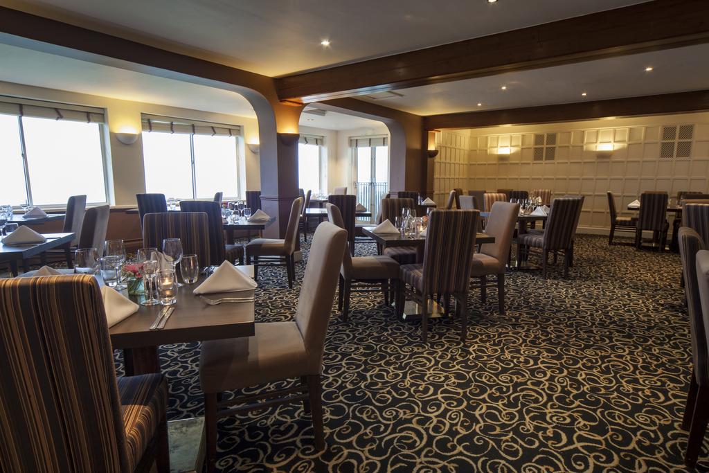 Restaurant with tables set ready for guests at Hellidon Lakes Golf & Spa Hotel