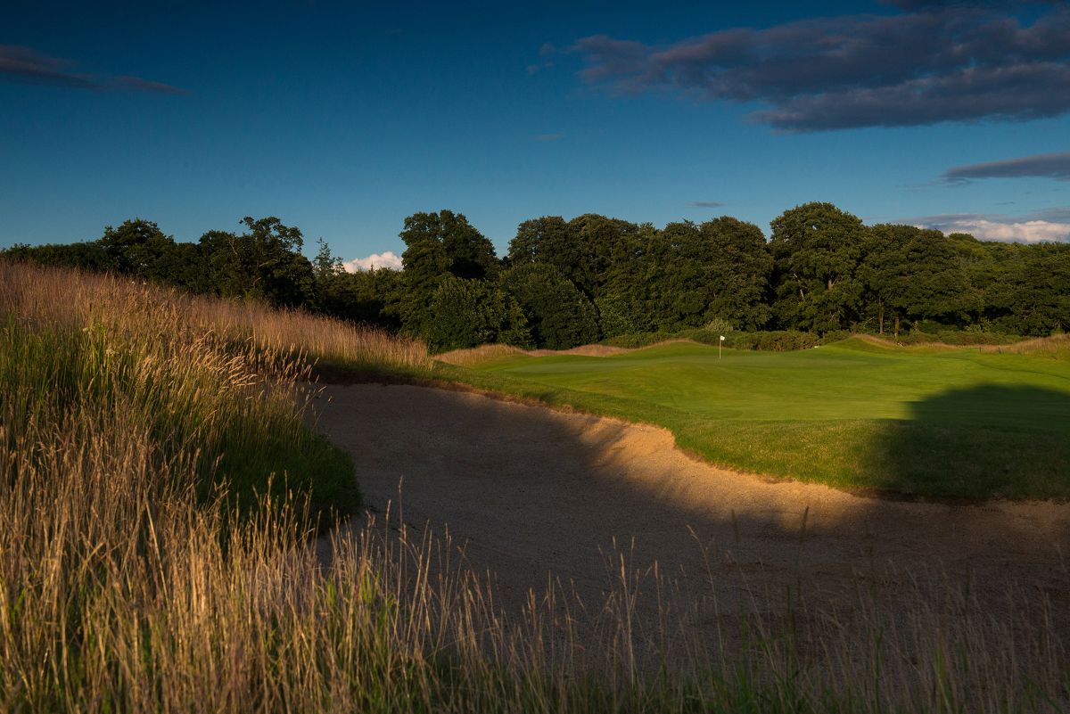 Large bunker in the foreground with pin on the putting green in the distance at Castlemartyr Golf Club