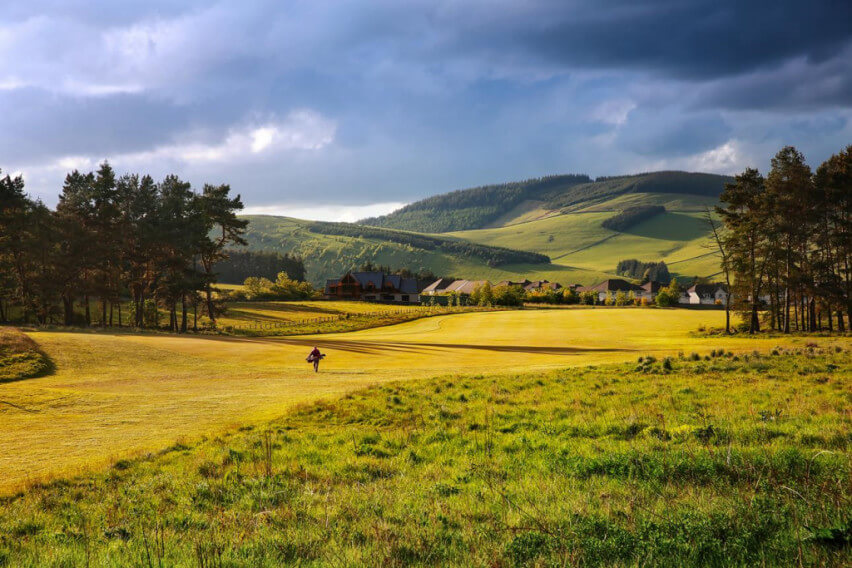 Golfer walking up the fairway of the golf course at Macdonald Cardrona Hotel Golf And Spa