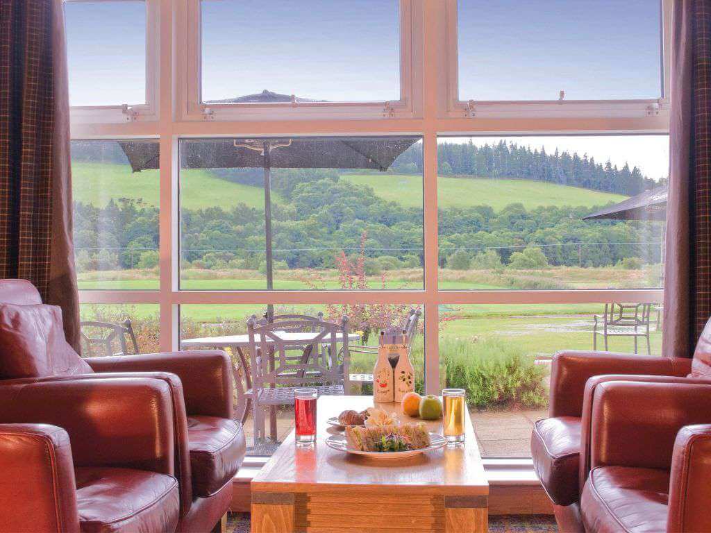 View through the window of the countryside from the bar at Macdonald Cardrona Hotel Golf And Spa